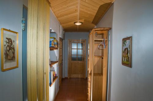a hallway with a wooden ceiling and a door at Lercherhof in Feld am See