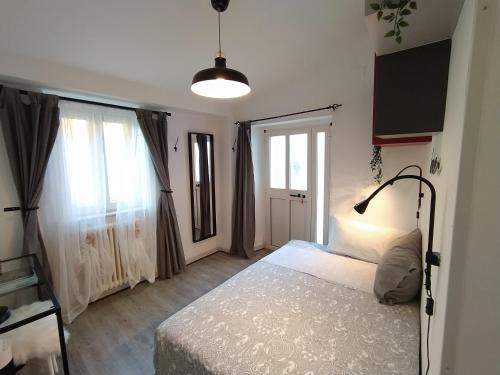 a bedroom with a bed and a large window at Casa in Centro Storico vista Gran Sasso in Atri