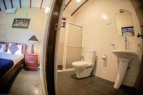 a bathroom with a toilet and a shower and a sink at Funk Bunks - Mount View in Kandy