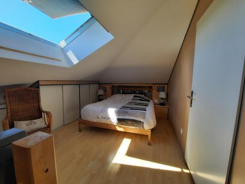 a attic bedroom with a bed and a skylight at Le boisnheur in Gap