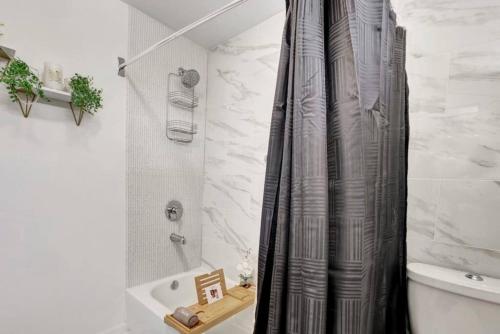 a shower curtain in a bathroom with a tub at Royalty in the Magic City in Birmingham