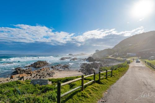 a road next to a beach with the ocean at No10@Kamma in Eersterivierstrand