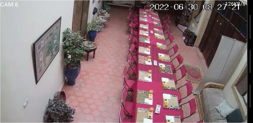 a restaurant with a long line of tables and chairs at dar wassim el ghali in Rabat