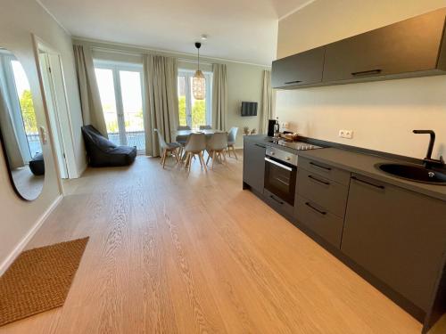 a kitchen with a counter and a table with chairs at Westeroog in Wangerooge