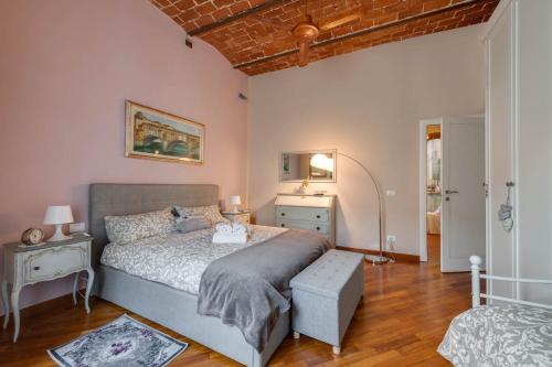 a bedroom with a large bed and a wooden floor at eLLe Apartments Firenze in Florence