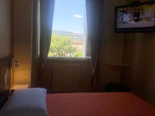 a bedroom with a bed and a window at La Finestra sul Fiume in Fossombrone