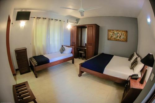 a bedroom with two beds and a desk and a chair at Funk Bunks - Mount View in Kandy