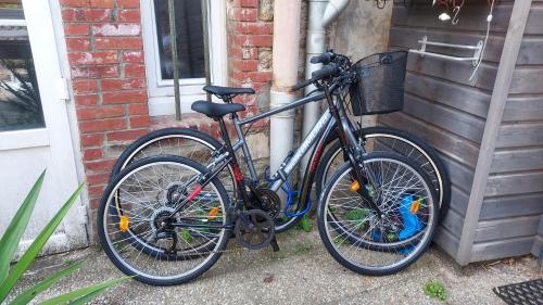 a bicycle is parked next to a house at Louisa in Dinard