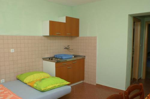 a kitchen with a sink and a bench with a pillow at Apartments by the sea Marusici, Omis - 2741 in Mimice