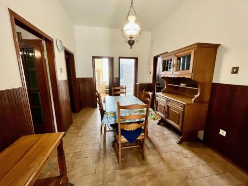 a dining room with a table and a piano at Casa Graziella in Cecina