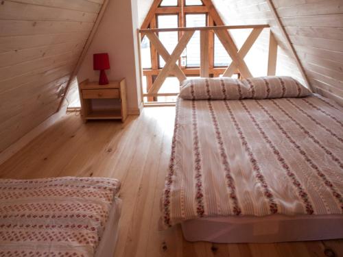 ein Schlafzimmer mit einem Bett und einem Tisch mit einer Lampe in der Unterkunft Dosbajka in Małastów