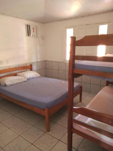 a bedroom with a bunk bed and a ladder at Pé de mato chalé in Estância