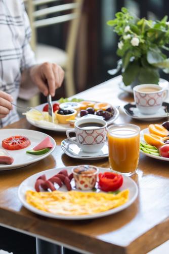 a table with plates of food and cups of coffee at EPHESUS CENTRUM in Selcuk