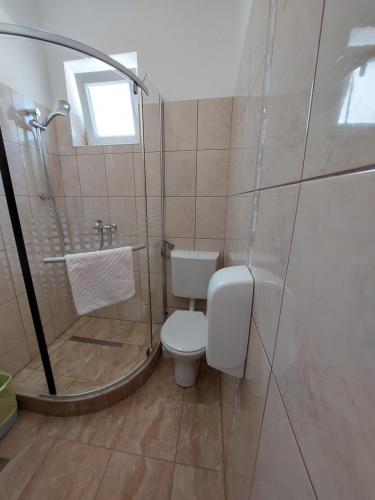 a bathroom with a toilet and a shower and a sink at Guest House Renata1 in Zadar