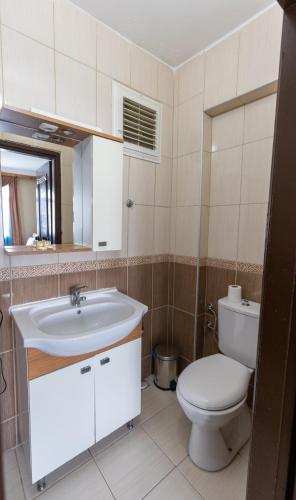 a bathroom with a white sink and a toilet at EPHESUS CENTRUM in Selcuk