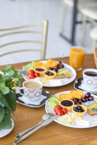 a table with plates of food and cups of coffee at EPHESUS CENTRUM in Selcuk