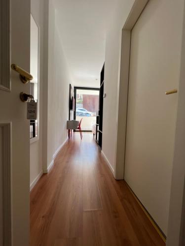 a hallway with a door leading to a living room at Wind Hotel in Malcesine