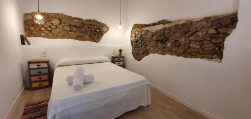 a bedroom with a bed with two towels on it at Alójate Gandia Ermita in Gandía