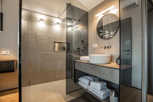 a bathroom with a sink and a mirror at Villa Bewegte Berge in Kaštelir