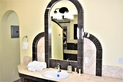 a bathroom with a sink and a mirror at HACIENDA MONARCAS Resort in Puerto Peñasco