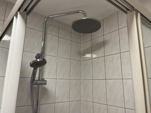 a shower with a shower head in a bathroom at Haus Monika in Kirchberg in Tirol