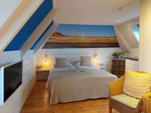 a bedroom with a large bed and a tv at Prins Appartementen in Egmond aan Zee