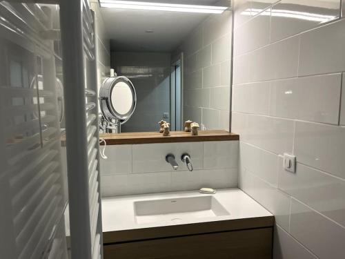 a bathroom with a sink and a mirror at Gîte de charme 5 étoiles pour couple avec sauna et jacuzzi extérieurs privatifs in Peaugres