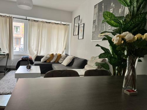 a living room with a couch and a table at Modern apartment with garden in Antwerp, 15min from City center in Antwerp