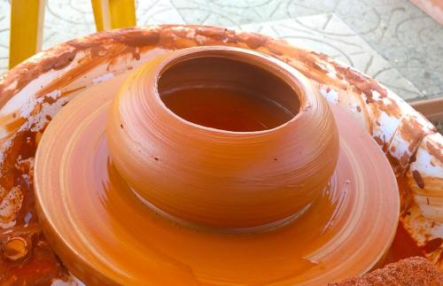 a vase sitting on top of a pot on a table at Pottery House Sanahin in Alaverdi
