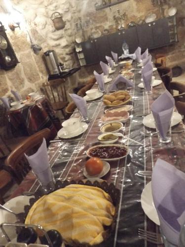 a long table with plates of food on it at BREAD HOUSE in Bethlehem