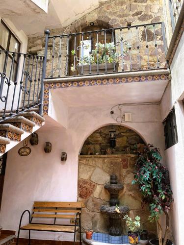 a room with a staircase and a table and bench at Noria House in Exhacienda La Escalera in Guanajuato