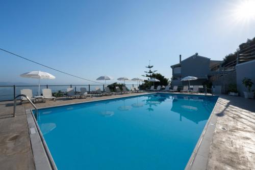 a large swimming pool with a view of the ocean at Golden Sunset in Boukari