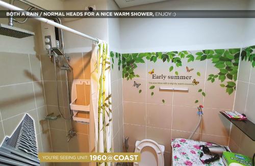 a bathroom with a shower withbaby summer stickers on the wall at Home Sweet Home at Manila Bay in Manila