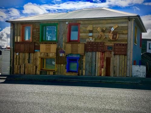 a wooden house with boxes on the side of it at Guesthouse 1x6 in Keflavík