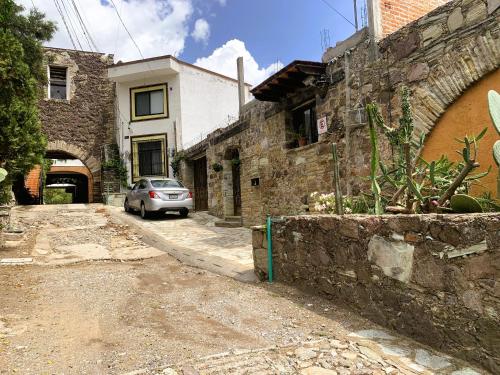 a car parked on a street next to a building at La Capelina Apartment in ExHacienda la Escalera in Guanajuato