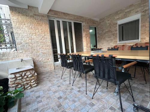 a table and chairs in a room with a brick wall at Relax Apartmani in Sutomore