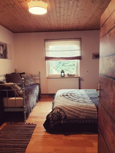a bedroom with a bed and a window with a window blind at Die Alm in Schöllbüchl, Privatzimmer in St. Martin
