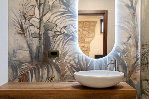 a bathroom with a sink and a mirror at DESTASU' Bed and Wellness in Castel del Monte