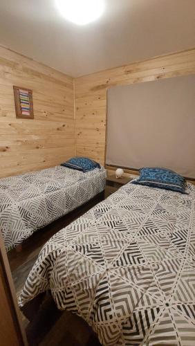 Una cama o camas en una habitación de Cabañas El Roble