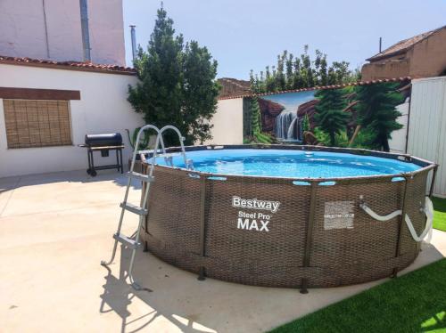 a hot tub in a yard with a sign that says everyday but be max at CASA RURAL VEGASAN in Santa Colomba de la Vega