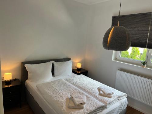 a bedroom with a bed with two towels on it at Allgäu SPA House in Blaichach