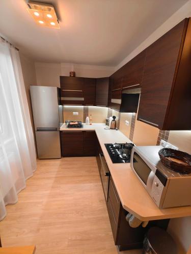 a kitchen with wooden cabinets and a counter top at Apartmán v centru in Karlovy Vary