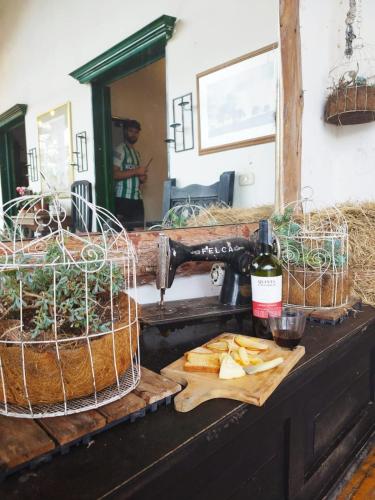 a kitchen counter with a sink with bread and baskets at Finca Campestre La Adelita B&B in Salento