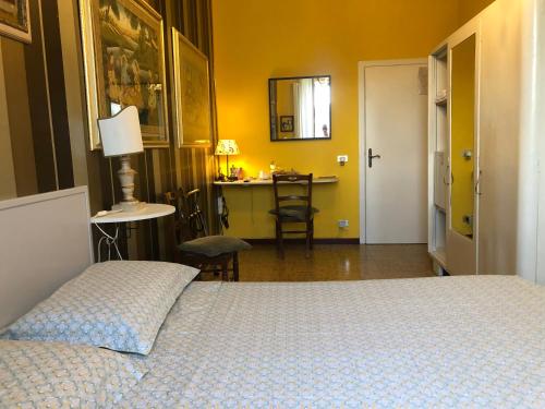 a bedroom with a bed and a table and a desk at La Finestra sul Fiume in Fossombrone