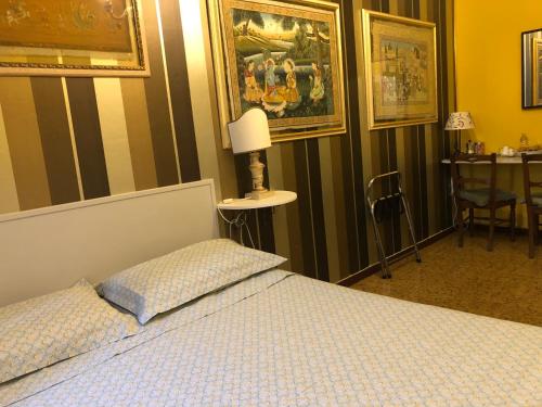 a bedroom with a bed with a lamp and a table at La Finestra sul Fiume in Fossombrone