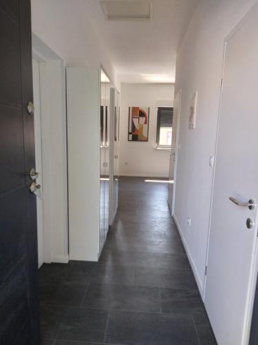 a hallway with white walls and a tile floor at Oasis in the city near Amfiteatar,free parking and free Wi-Fi in Pula