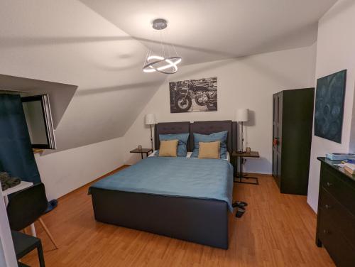 a bedroom with a bed with a blue bedspread at Schönes 2 Zimmer Appartment in der Altstadt von Koblenz in Koblenz