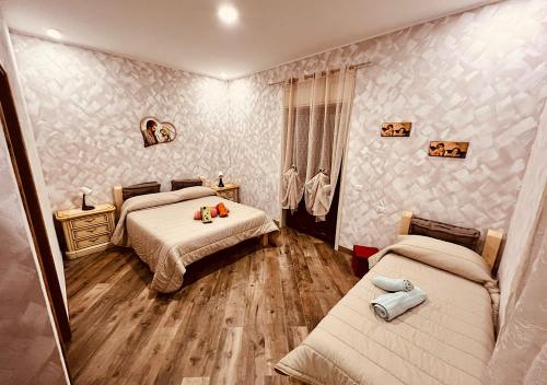 a bedroom with two beds and a mirror at Chalet Grotta Monte Etna in Maletto