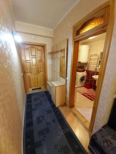 a small kitchen with a door open to a room at Atgiris in Palanga