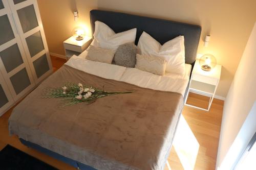 a large bed with white pillows and flowers on it at Luxury Villa Meerbrise - Private Pool - Near Medulin, Kamenjak, Pola in Banjole